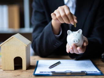 Businesswoman, real estate agent calculating savings by real estate budget.